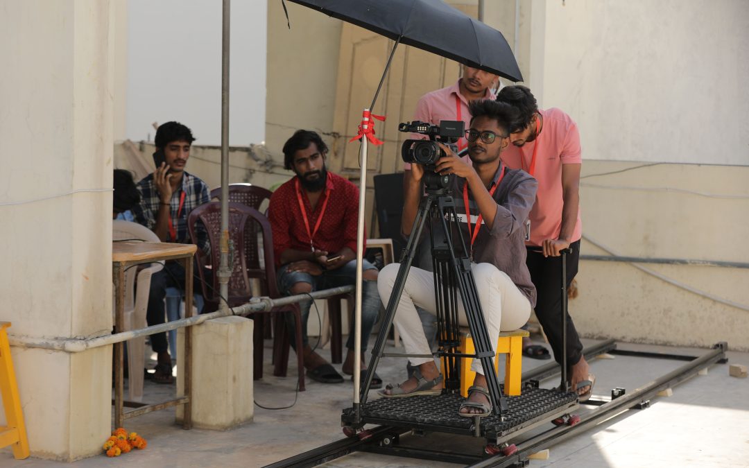 How do cinematographers use camera movements and angles to influence the audience’s perspective?